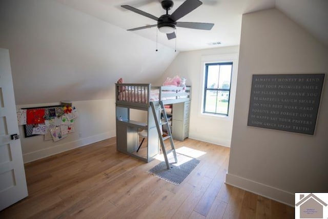 bedroom featuring ceiling fan, vaulted ceiling, and wood-type flooring