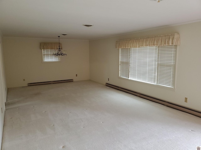 carpeted spare room featuring plenty of natural light and baseboard heating