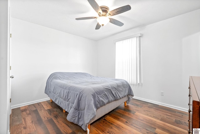 bedroom with ceiling fan and dark hardwood / wood-style flooring