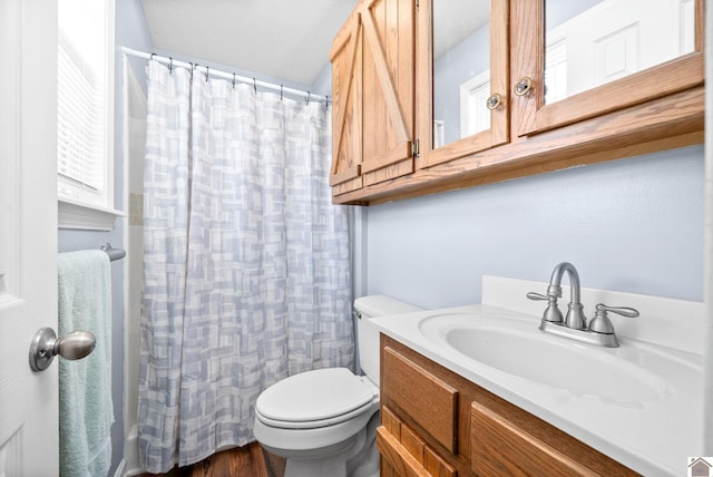 bathroom featuring vanity, hardwood / wood-style flooring, curtained shower, toilet, and a textured ceiling