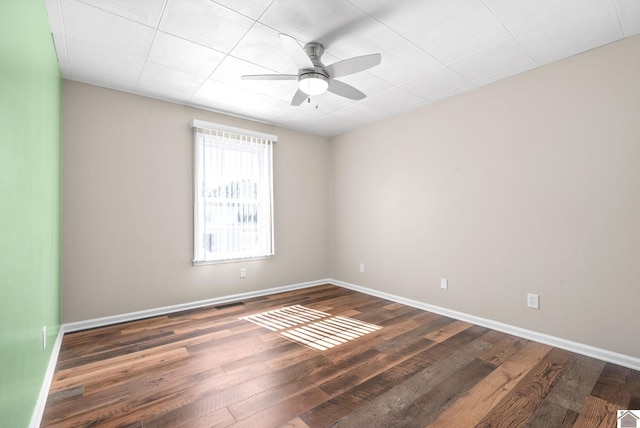 empty room featuring ceiling fan and dark hardwood / wood-style flooring