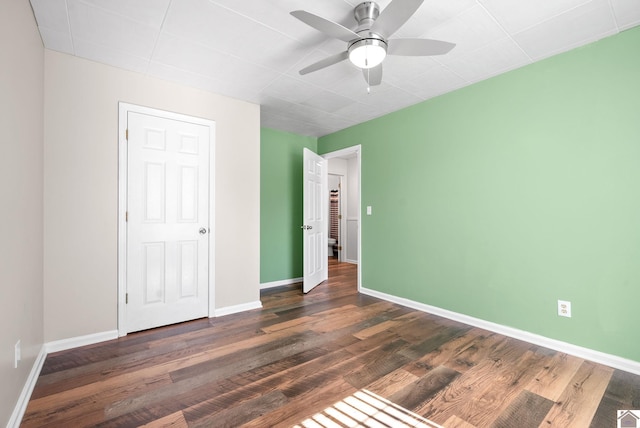 unfurnished bedroom featuring dark hardwood / wood-style floors and ceiling fan