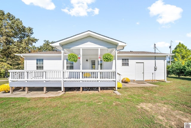 rear view of property featuring a lawn and a wooden deck