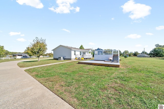 view of front facade featuring a wooden deck and a front lawn