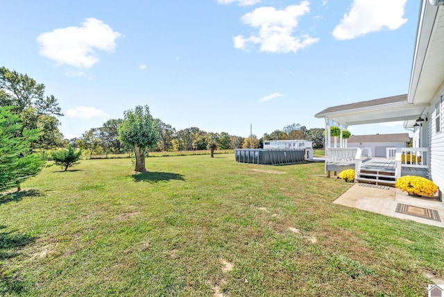 view of yard featuring a patio and a pool