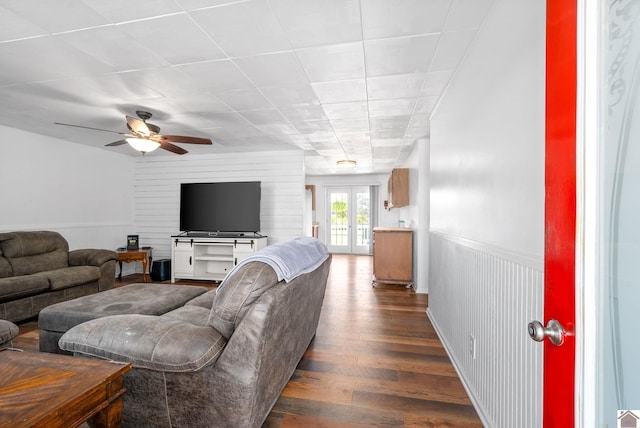 living room featuring ceiling fan, french doors, and dark hardwood / wood-style flooring