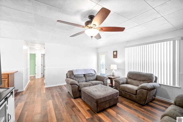 living room featuring dark hardwood / wood-style floors and ceiling fan