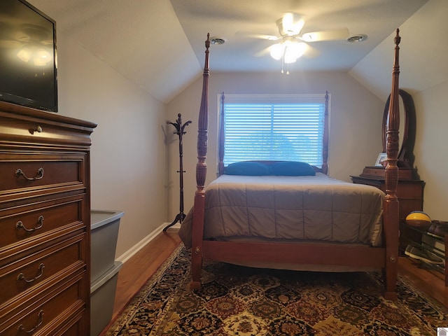 bedroom with ceiling fan, lofted ceiling, and dark wood-type flooring