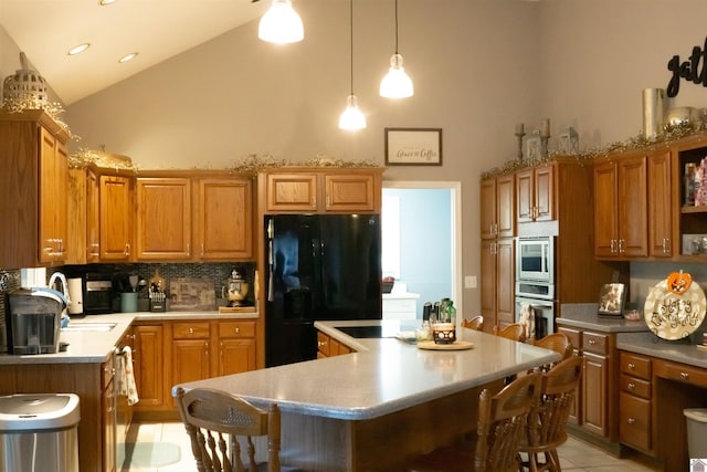 kitchen with a kitchen island, light tile patterned floors, stainless steel appliances, and a breakfast bar