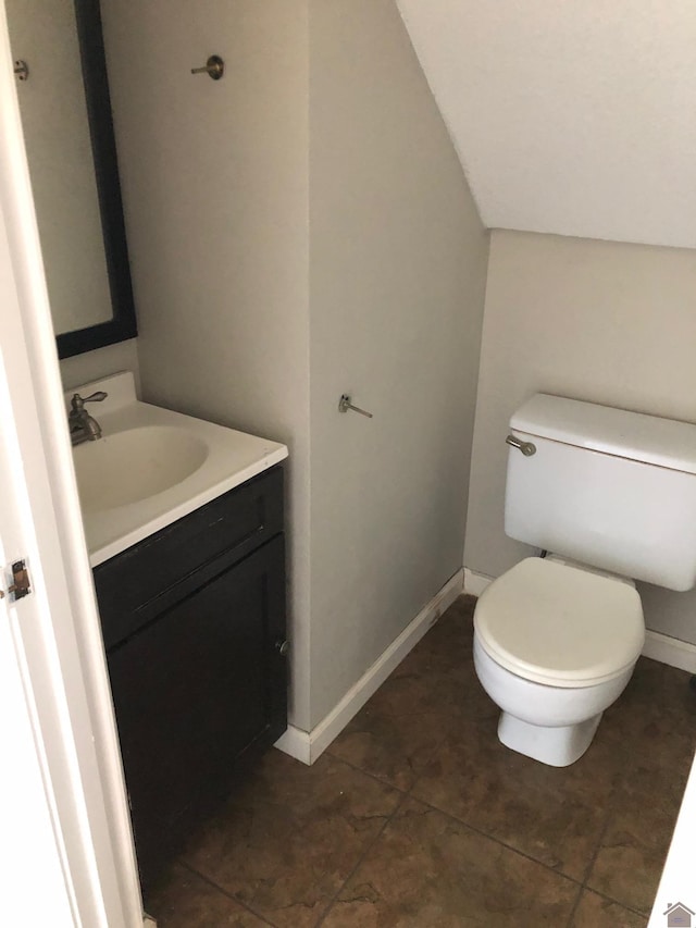 bathroom featuring vanity, toilet, and tile patterned flooring