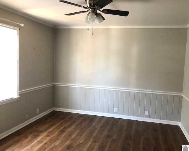 spare room featuring ornamental molding, dark wood-type flooring, and ceiling fan