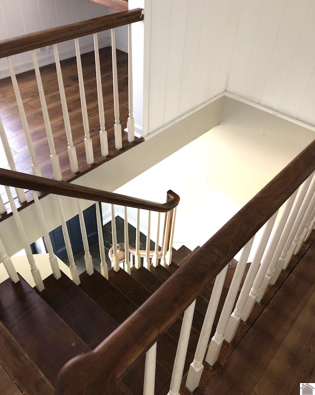 staircase with hardwood / wood-style floors