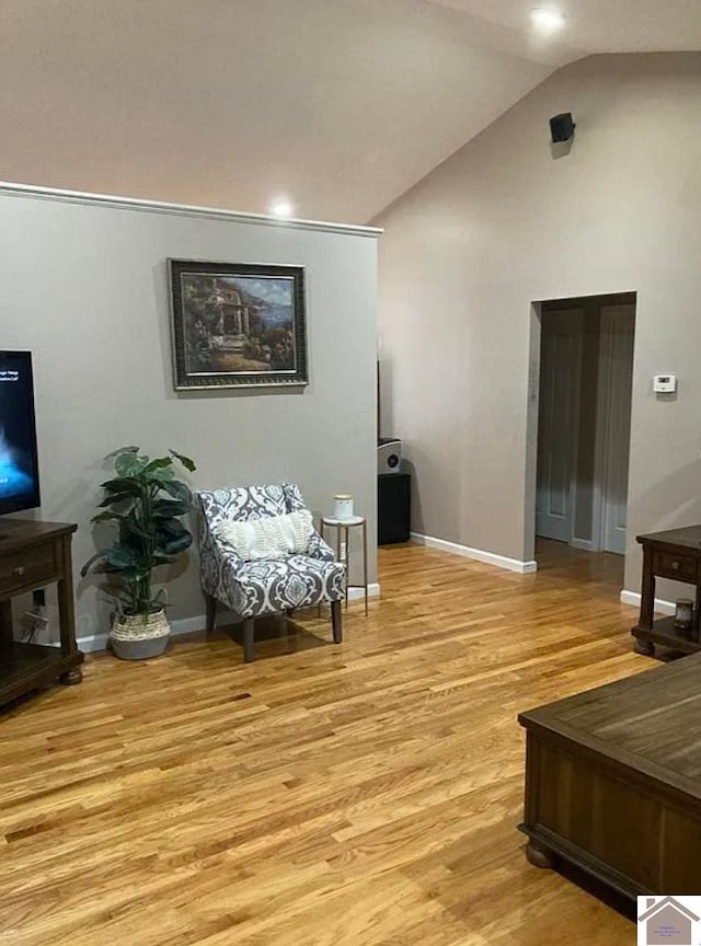 sitting room with lofted ceiling and light hardwood / wood-style floors