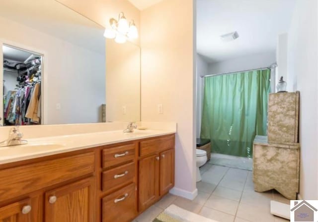 bathroom featuring tile patterned floors, a shower with shower curtain, vanity, and toilet