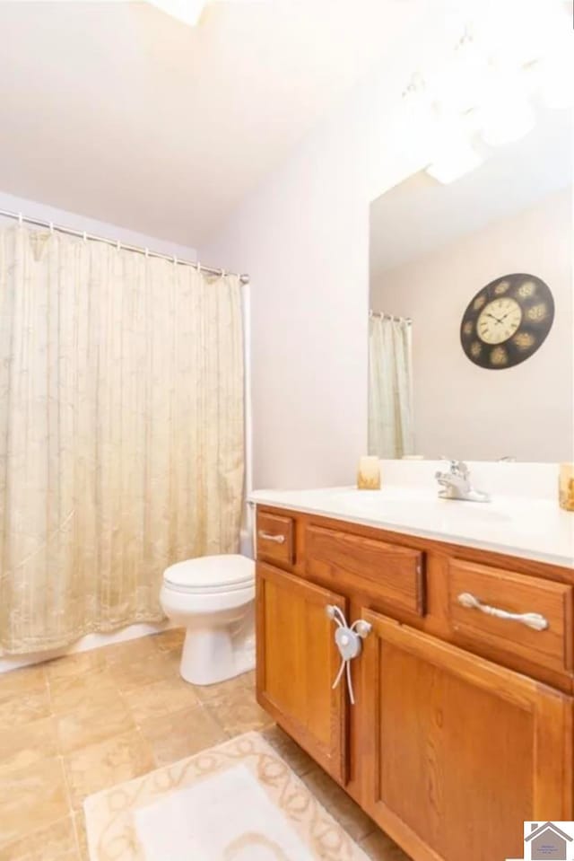 bathroom with toilet, vanity, and a shower with shower curtain