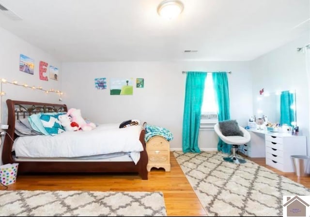 bedroom with hardwood / wood-style flooring