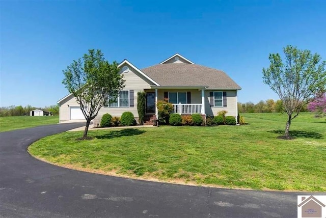 single story home with a garage, a front lawn, and covered porch