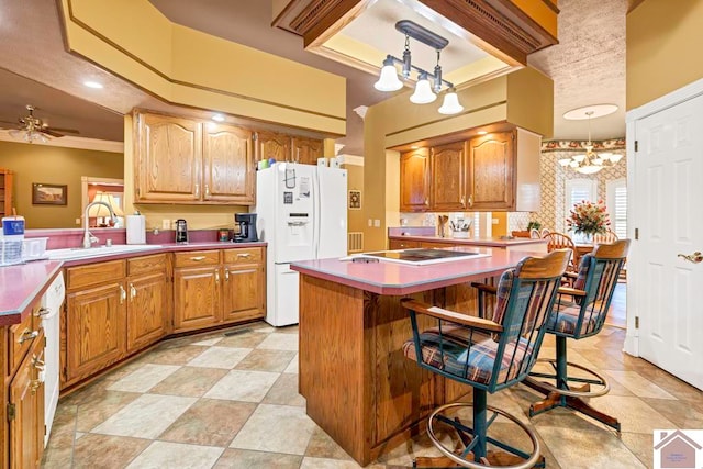 kitchen featuring a kitchen breakfast bar, ornamental molding, sink, decorative light fixtures, and white appliances