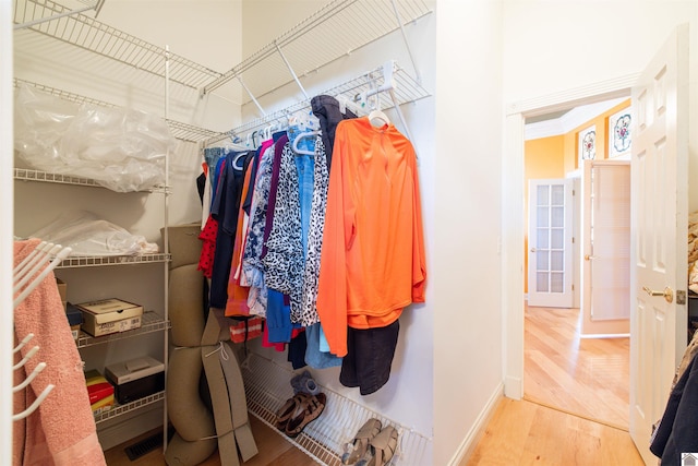 spacious closet with hardwood / wood-style flooring