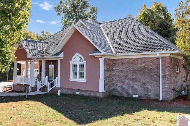 view of property exterior featuring a porch and a yard