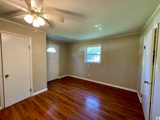 unfurnished bedroom with ornamental molding, ceiling fan, and dark hardwood / wood-style floors