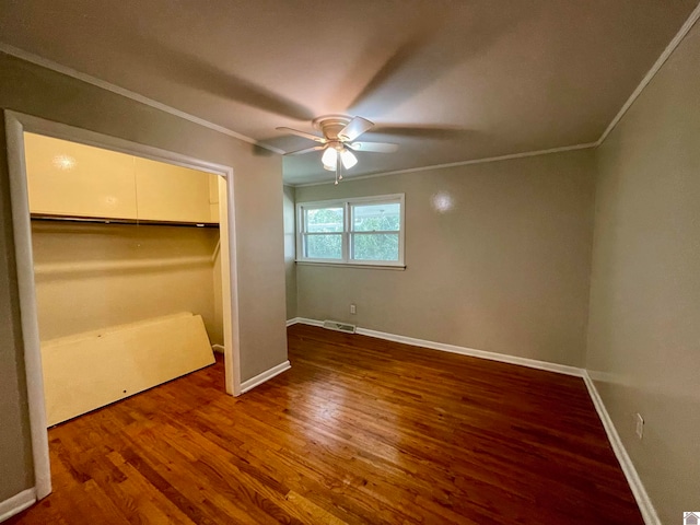 unfurnished bedroom with crown molding, ceiling fan, a closet, and hardwood / wood-style floors