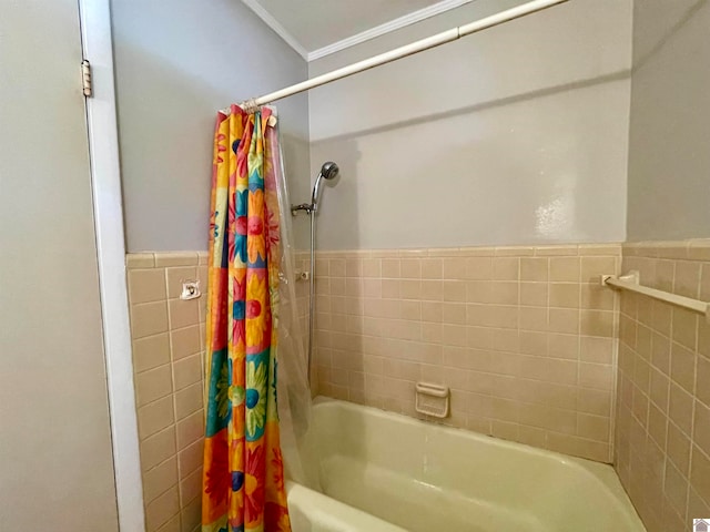 bathroom with ornamental molding, shower / bath combo, and tile walls