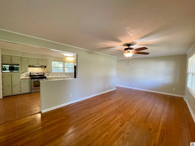 unfurnished living room featuring ceiling fan, light wood-type flooring, and crown molding