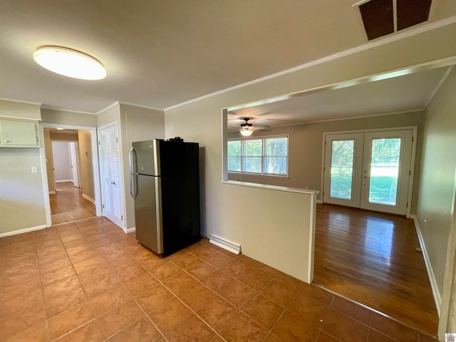 kitchen with light hardwood / wood-style flooring, ornamental molding, stainless steel fridge, and ceiling fan