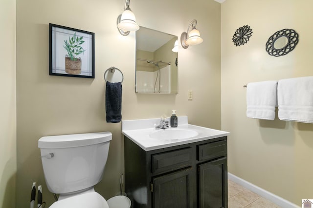 bathroom with vanity, toilet, and tile patterned floors