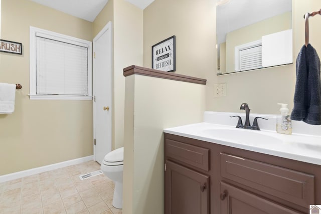 bathroom with vanity, toilet, and tile patterned flooring