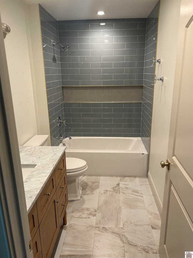 full bathroom featuring vanity, toilet, and tiled shower / bath