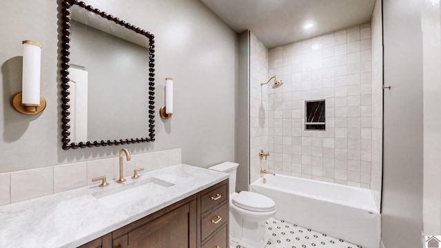 full bathroom with vanity, toilet, tile patterned flooring, and tiled shower / bath