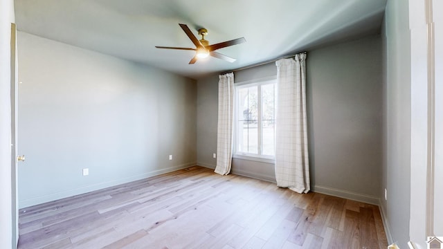 empty room featuring light wood-type flooring and ceiling fan