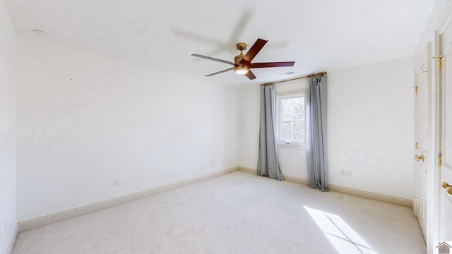 carpeted empty room featuring ceiling fan