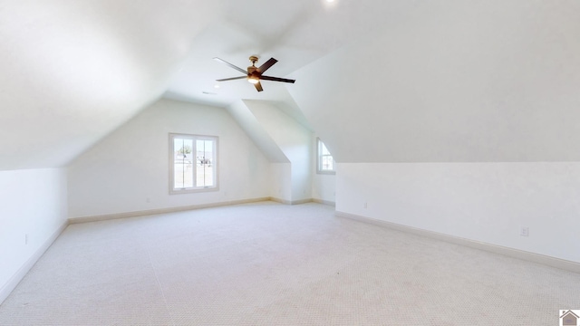 bonus room with ceiling fan, light colored carpet, and vaulted ceiling