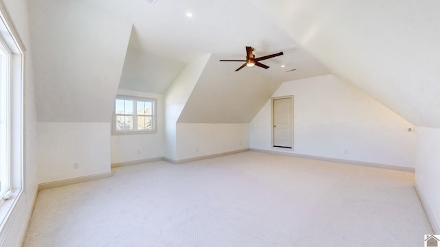 bonus room with ceiling fan, light colored carpet, and vaulted ceiling