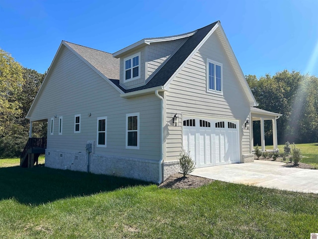 view of home's exterior featuring a garage and a lawn