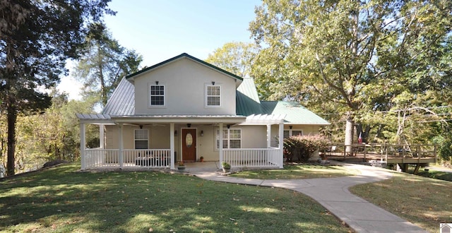 farmhouse with a porch and a front lawn