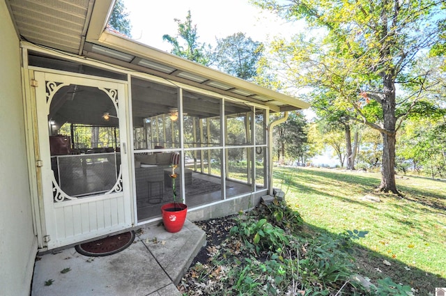 view of exterior entry with a lawn