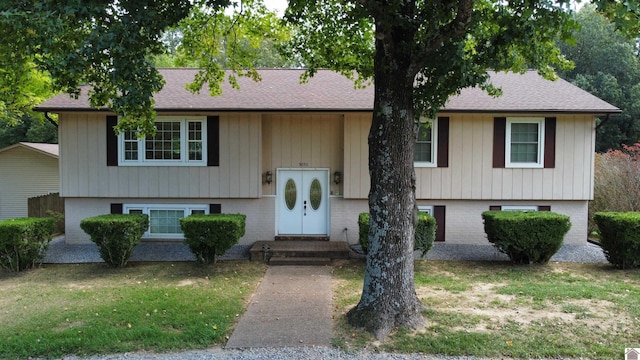 raised ranch with a front lawn