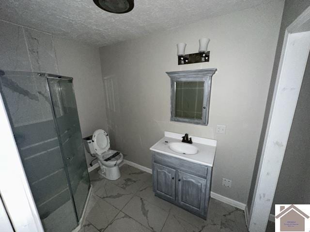 full bathroom with a shower stall, a textured ceiling, marble finish floor, and vanity