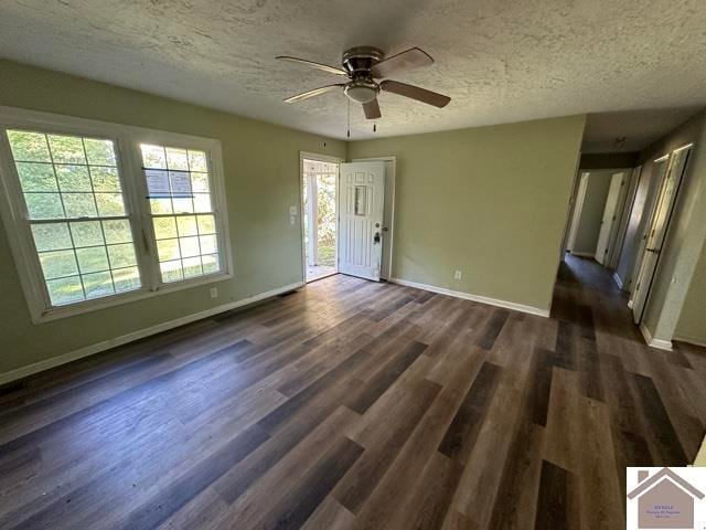 unfurnished room featuring a textured ceiling, dark hardwood / wood-style floors, and ceiling fan