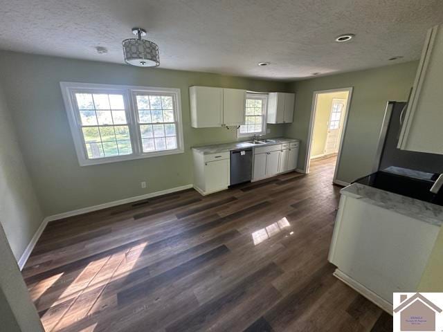 kitchen featuring sink, pendant lighting, stainless steel dishwasher, white cabinets, and dark wood-type flooring