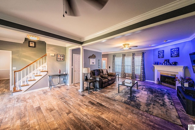 living room with ornamental molding, decorative columns, hardwood / wood-style flooring, and ceiling fan