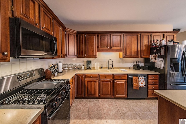 kitchen with sink, black appliances, decorative backsplash, and light tile patterned flooring