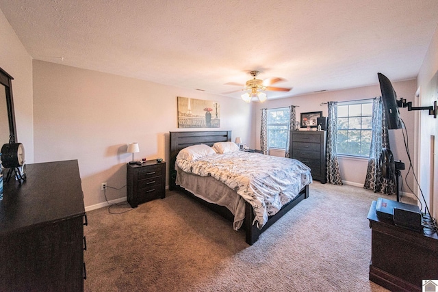 bedroom featuring ceiling fan, a textured ceiling, and carpet floors