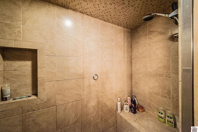 bathroom with tiled shower