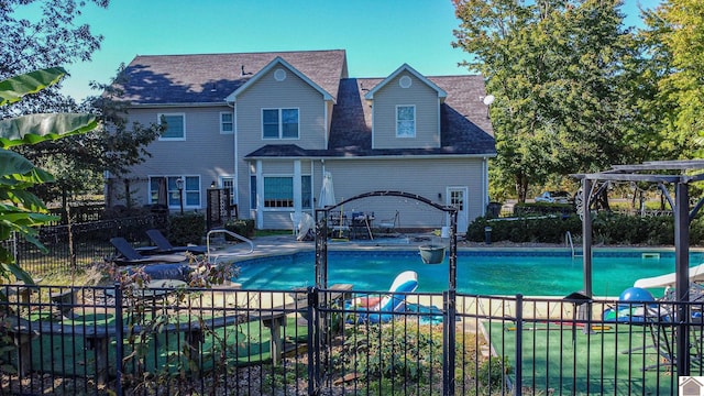 view of swimming pool with a patio area and a water slide