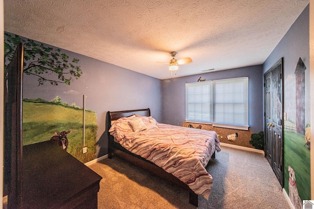 carpeted bedroom with ceiling fan and a textured ceiling